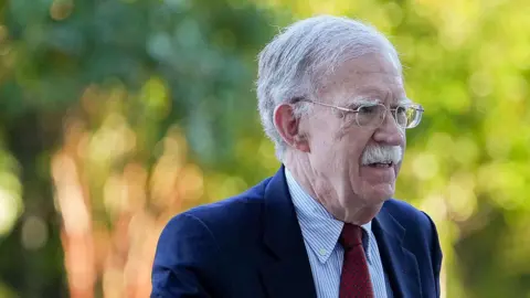 Bloomberg via Getty Images Former national security adviser John Bolton arrives at court on Friday.