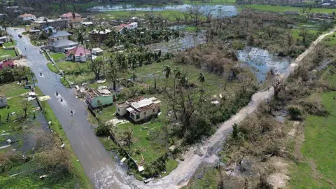AFP via Getty Images An overhead shot of roads flooded and the grassland saturated with water