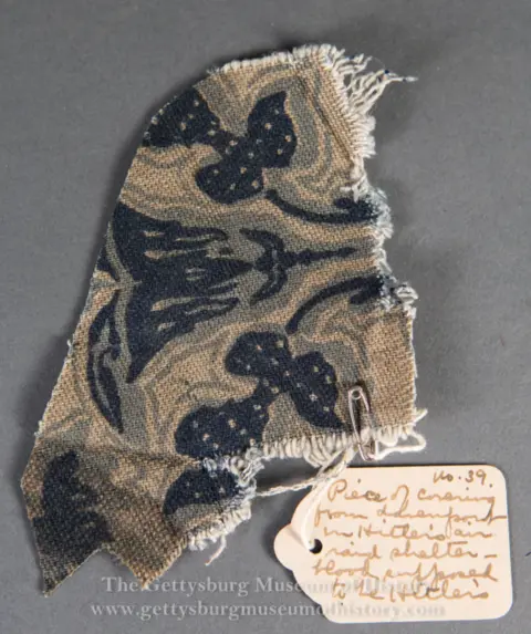 Gettysburg Museum of History A brown and blue ripped swatch of fabric that looks quite dirty.