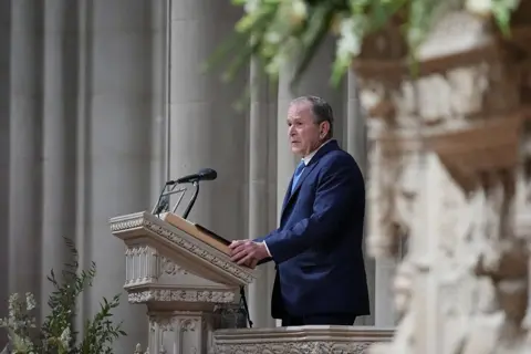 Getty Images George W Bush at a podium speaking at Cheney's funeral