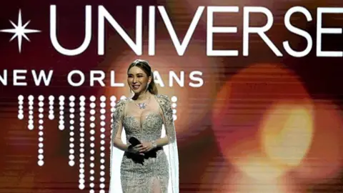 Getty Images Woman wearing beaded gown standing on stage