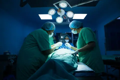 Getty Images Indian surgeons medical team performing surgery in operation theater at hospital