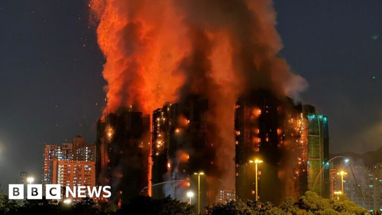 At least 13 dead as fire engulfs Hong Kong tower blocks
