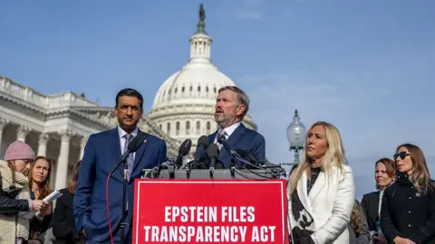 Getty Images Members of Congress stand outside Capitol and behind sign that reads “Epstein Files Transparency Act” 