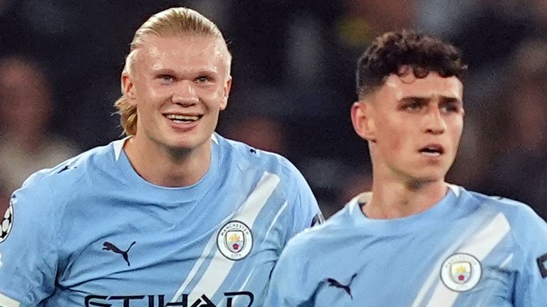 Erling Haaland celebrates with Phil Foden after scoring a goal against Borussia Dortmund
