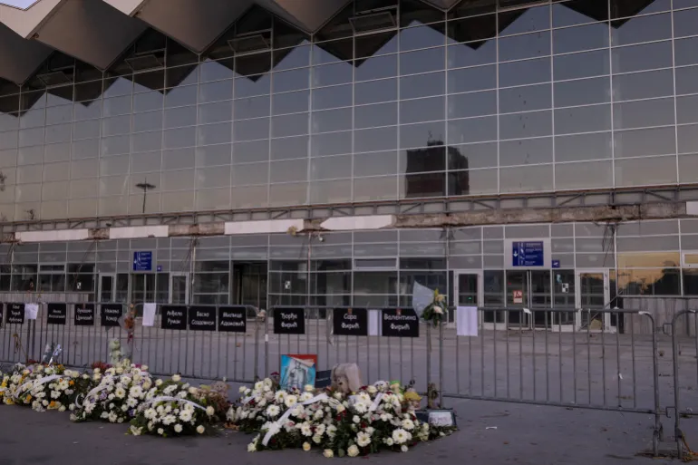 Flowers are laid under the names of victims at the entrance of the Novi Sad railway station