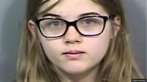 Police handout A young Morgan Geyser wearing glasses looks in the camera for a mugshot.