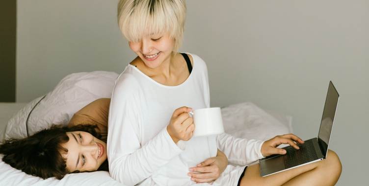 A person holding a cup and lying on a bed
AI-generated content may be incorrect.