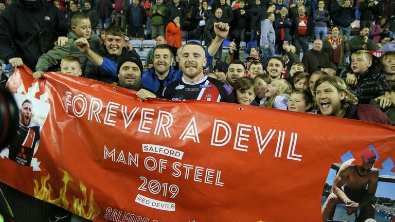 Salford reds Jackson Hastings celebrates with fans after beating Wigan to make the final of the Betfred Super League