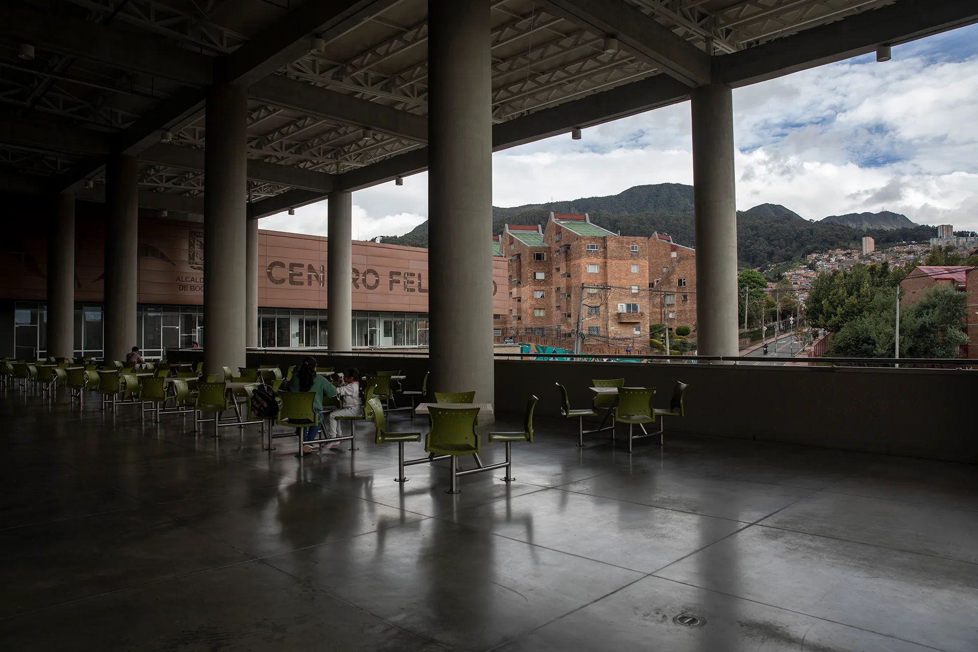 a view of Bogotá, Colombia from an outdoor seating area attached to a large multi-use building
