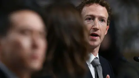 Getty Images Mark Zuckerberg, in a suit and grey tie, is seen speaking during a Senate Judiciary Committee