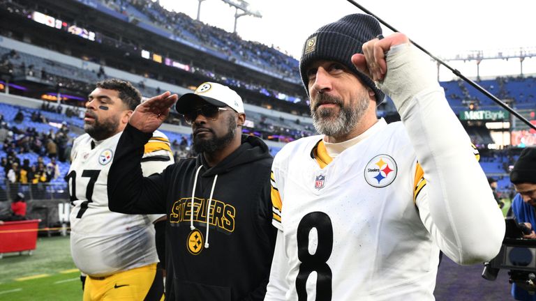 Pittsburgh Steelers head coach Mike Tomlin and quarterback Aaron Rodgers (8) leave the field after an NFL football game against the Baltimore Ravens, Sunday, Dec. 7, 2025, in Baltimore. (AP Photo/Nick Wass)