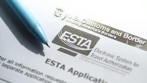 Getty Images A pen laid atop a paper form labelled Electronic System for Travel Authorization (ESTA)