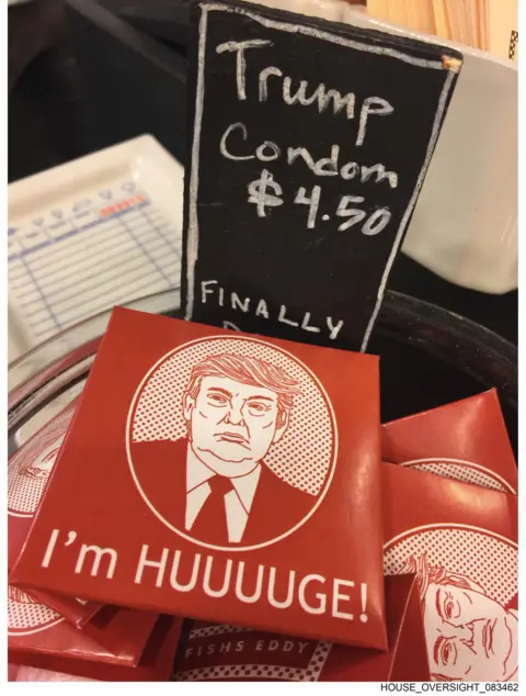House Oversight Committee Photo showing an illustrated likeness of the president on red packets next to a sign that reads: "Trump Condom".