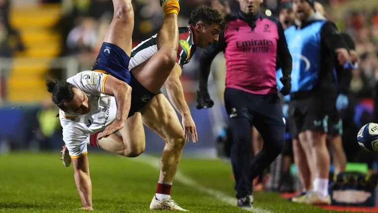  Lowe is tackled by Leicester's Adam Radwan