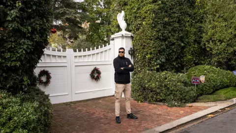 EPA A guard stands in front of the Reiner home