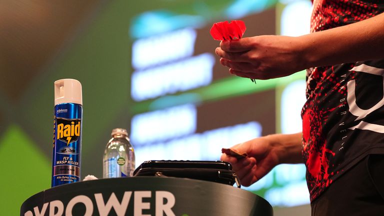 Jurjen van der Velde with a fly and wasp spray on the water table on day six of the Paddy Power World Darts Championship at the Alexandra Pa