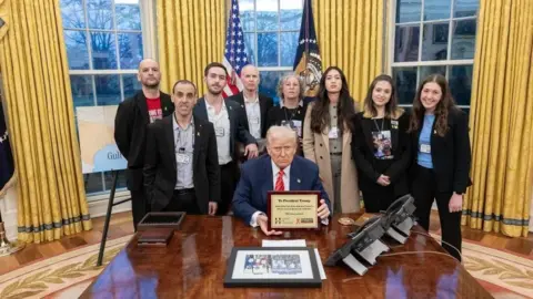 The White House US President Donald Trump meets six former hostages - left to right: Iair Horn, Eli Sharabi, Omer Shem Tov, Keith Siegel, Aviva Siegel, Noa Argamani, Doron Steinbrecher, and Naama Levy - at the White House on 6 March 2025