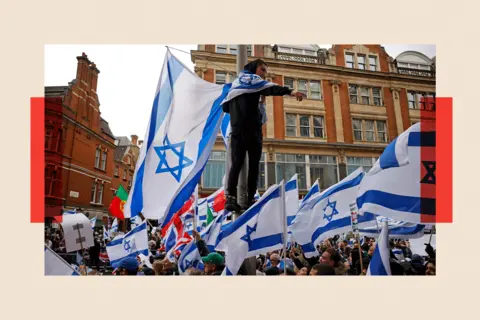 AFP via Getty Image Protesters with Israeli flags rally in support of Israel outside the Israeli Embassy in central London