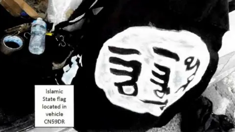 Supplied A black and white IS flag inside a car