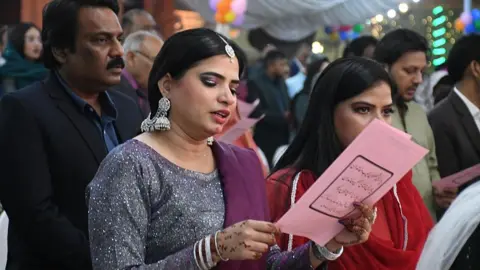 Getty Images Pakistani Christians attend midnight Christmas Mass at Central Brooks Memorial Church in Karachi, Pakistan on 24 December 2025.