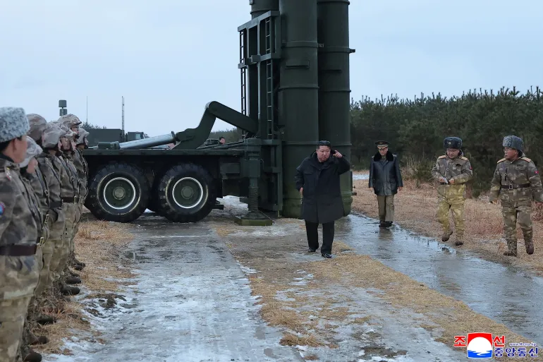 This picture taken on December 24, 2025 and released by North Korea's official Korean Central News Agency (KCNA) via KNS on December 25, 2025 shows North Korean leader Kim Jong Un observing a test-fire of a new-type anti-air missiles at an undisclosed location in North Korea. (Photo by KCNA VIA KNS / AFP) / South Korea OUT / SOUTH KOREA OUT / SOUTH KOREA OUT / ---EDITORS NOTE--- RESTRICTED TO EDITORIAL USE - MANDATORY CREDIT "AFP PHOTO/KCNA VIA KNS" - NO MARKETING NO ADVERTISING CAMPAIGNS - DISTRIBUTED AS A SERVICE TO CLIENTS THIS PICTURE WAS MADE AVAILABLE BY A THIRD PARTY. AFP CAN NOT INDEPENDENTLY VERIFY THE AUTHENTICITY, LOCATION, DATE AND CONTENT OF THIS IMAGE. /