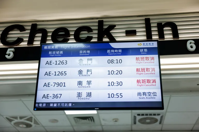 A display screen shows information on cancelled flights at Taipei Songshan Airport, as China conducts "Justice Mission 2025" military drills around Taiwan, in Taipei, Taiwan, December 30, 2025. REUTERS/Ann Wang