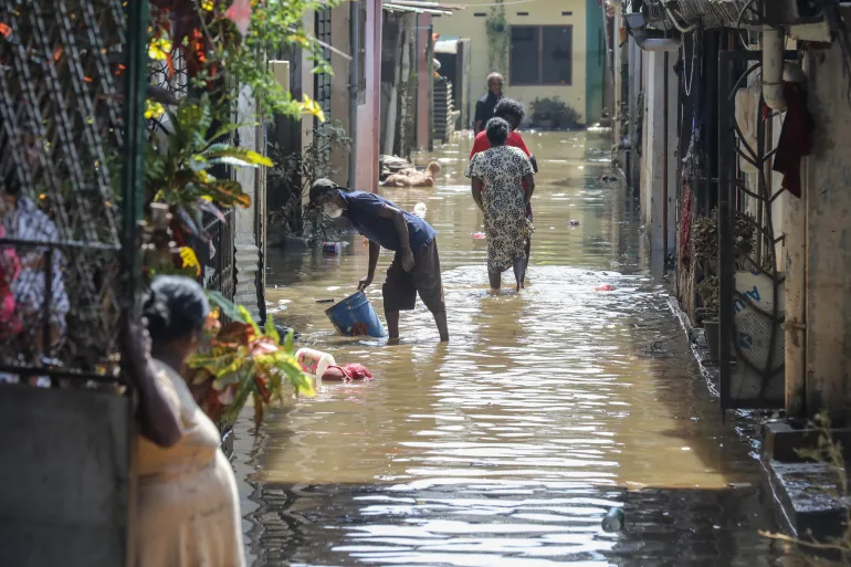 epa12566451 Sri Lankan flood-affected people clean their mud- and water-covered home in a flood-affected village in a suburb of Colombo, Sri Lanka, 03 December 2025. According to the Sri Lanka Disaster Management Center, more than 470 people have been killed, and 376 went missing around the country due to the floods caused due to heavy rains. EPA/CHAMILA KARUNARATHNE