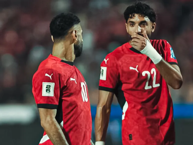 Omar Marmoush and Mohamed Salah react.
