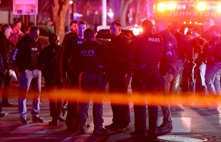 Police gather on Waterman Street in Providence, R.I., on Saturday, Dec. 13, 2025, during the investigation of a shooting. (AP Photo/Mark Stockwell)