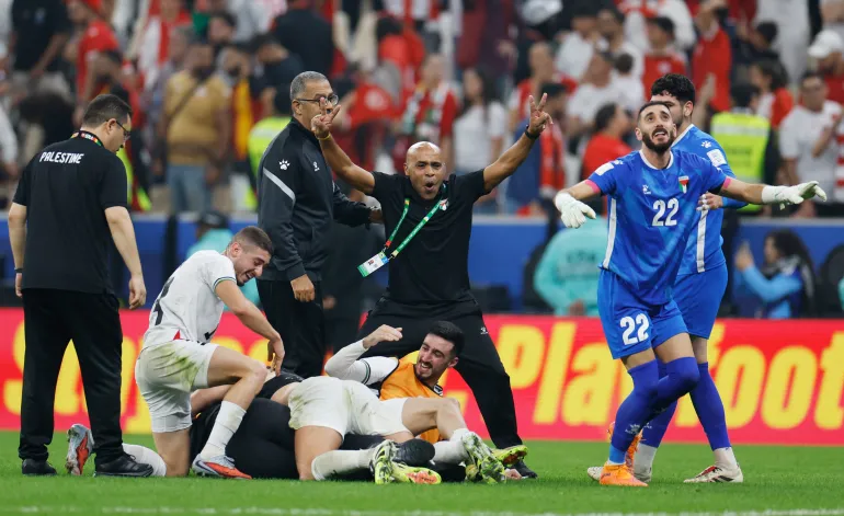 Palestine's Ikram Rami Hamadeh celebrates with teammates after the match