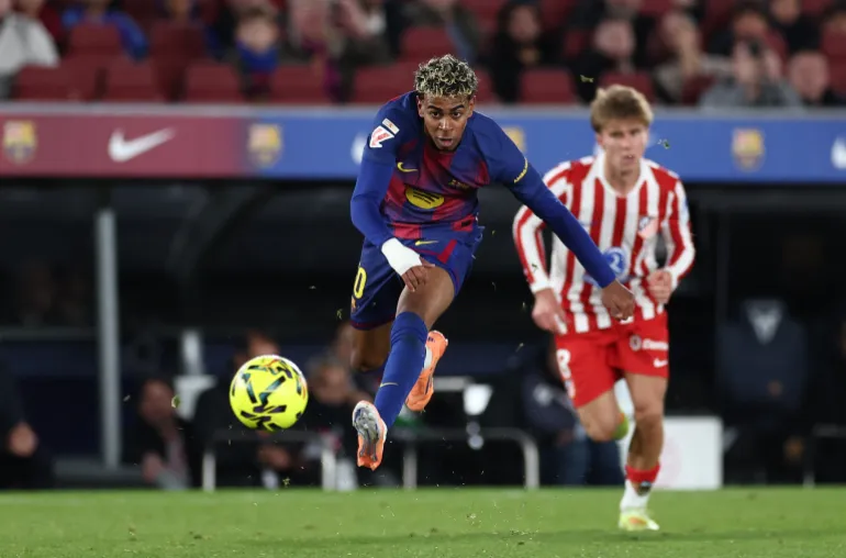 TOPSHOT - Barcelona's Spanish forward #10 Lamine Yamal kicks the ball during the Spanish league football match between FC Barcelona and Club Atletico de Madrid at Camp Nou Stadium in Barcelona on December 2, 2025. (Photo by Josep LAGO / AFP)
