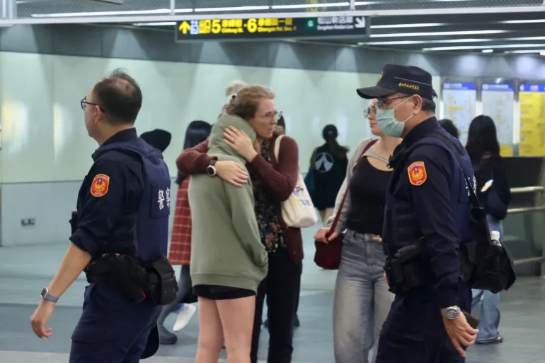 TOPSHOT - This picture taken and released by Taiwan's Central News Agency (CNA) on December 19, 2025 shows police patrolling at a metro station in Taipei, after attacks at two stations in the city.
