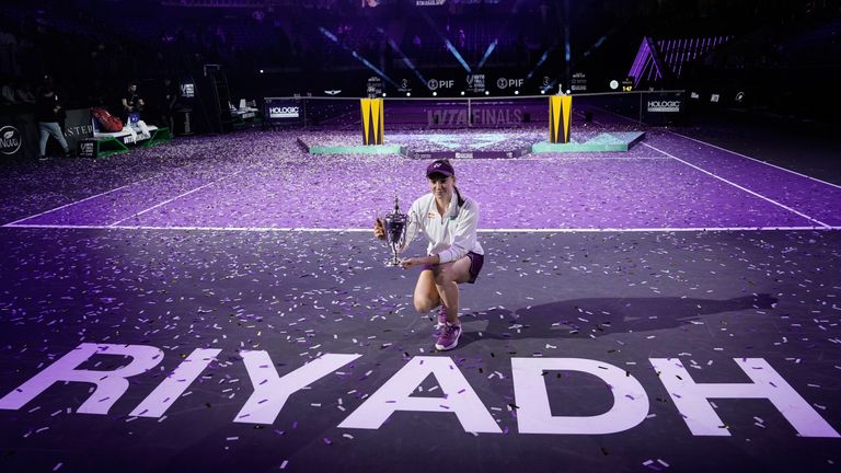 Elena Rybakina of Kazakhstan poses with the trophy after defeating Aryna Sabalenka of Belarus in the women's final singles match of the WTA finals in Riyadh, Saudi Arabia, Saturday, Nov. 8, 2025. (AP Photo/ Fatima Shbair)