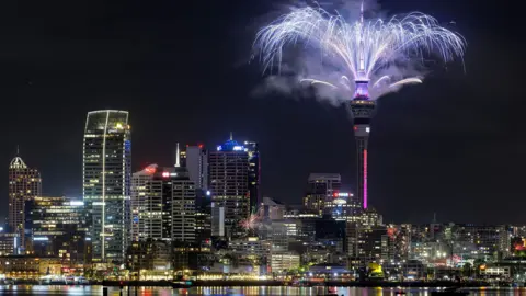 Shutterstock A city skyline with a firework display from the top of Auckland's Sky Tower