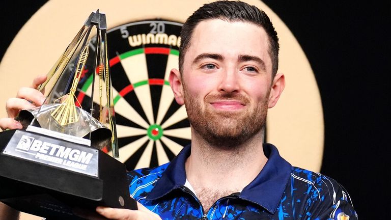 Luke Humphries celebrates with Premier League trophy