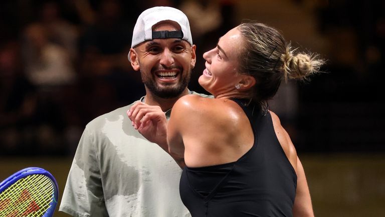 Nick Kyrgios, left, and Aryna Sabalenka interact at the net during their Battle of the Sexes match, in Dubai, United Arab Emirates, Sunday Dec. 28, 2025. (Christopher Pike/Pool Photo via AP)