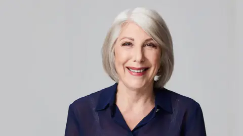 ABC An older woman with grey hair smiles at the camera.