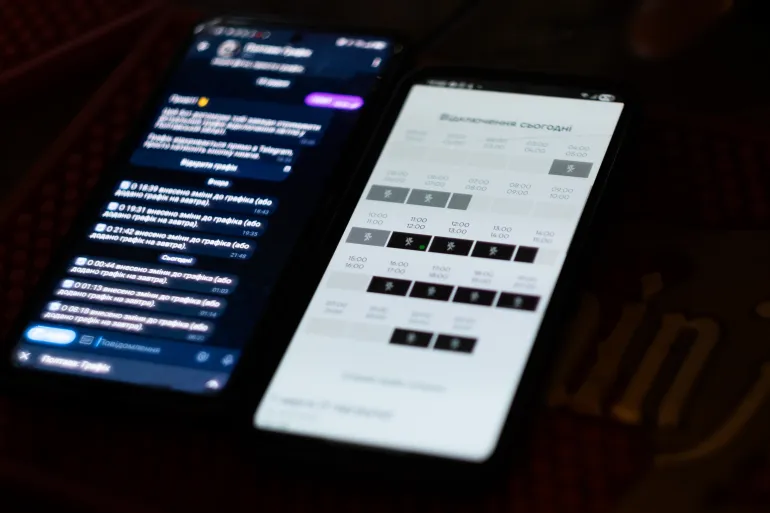 Maxim Senchuk shows an app which indicates when electricity will be available in his area (Nils Adler/Al Jazeera)