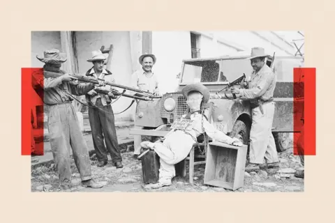 Getty Images A black and white photo shows an effigy of former Guatemalan President Jacobo Arbenz propped against a Jeep as men in hats train guns on it. The effigy has a placard, which says (in Spanish) "I am going back to Russia". 
