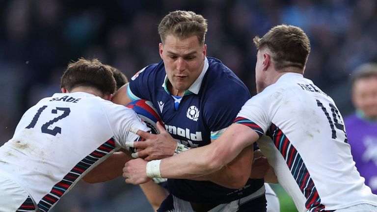 Scotland's Duhan van der Merwe, center, is tackled by England's Henry Slade, Marcus Smith and Tommy Freeman, from left, during the Six Nations rugby union match between England and Scotland at Twickenham in London, Saturday, Feb. 22, 2025. (AP Photo/Ian Walton)