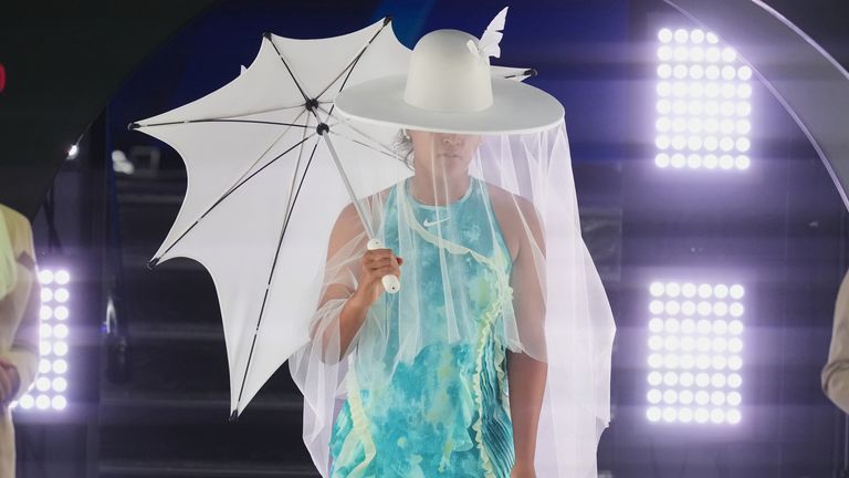 Naomi Osaka of Japan walks onto Rod Laver Arena for her first round match against Antonia Ruzic of Croatia at the Australian Open tennis championship in Melbourne, Australia, Tuesday, Jan. 20, 2026. (AP Photo/Asanka Brendon Ratnayake)
