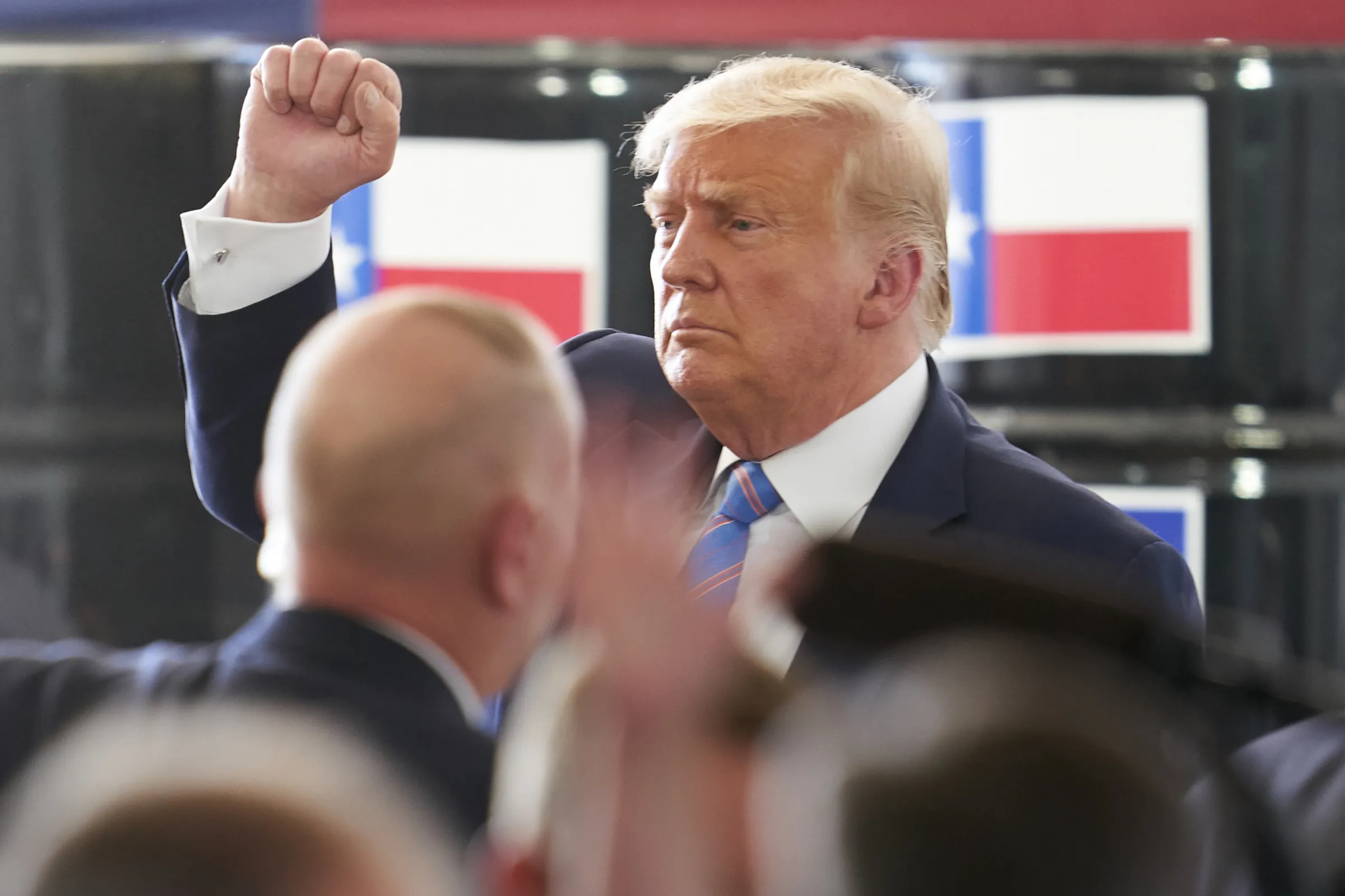 Trump stands with his fist in the air