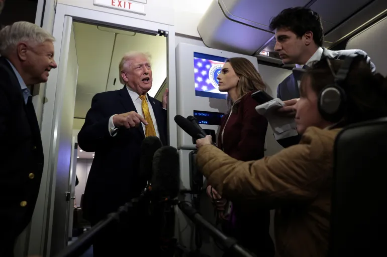 U.S. President Donald Trump speaks to reporters aboard Air Force One en route from Florida to Joint Base Andrews, Maryland, U.S., January 4, 2026. REUTERS/Jonathan Ernst