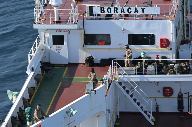 This aerial picture taken on October 1, 2025 off the coast of the western France port of Saint-Nazaire shows French soldiers onboard the tanker from Russia's so-called "shadow fleet" suspected of being involved in drone flights over Denmark which sailed off the Danish coast between September 22 and 25. Named the Pushpa or Boracay, the Benin-flagged vessel, which is blacklisted by the European Union for being part of Russia's sanction-busting "shadow fleet", has been immobilised for several days off the French coast. (Photo by Damien MEYER / AFP)