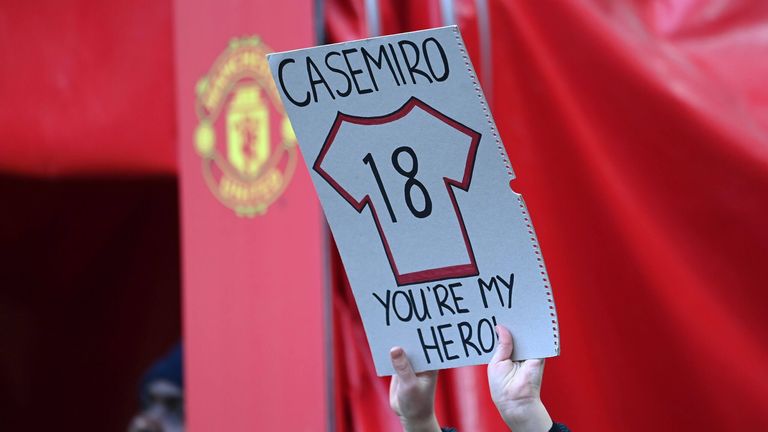A fan holds a sign with a No.18 shirt on it and a caption that reads: "You're my hero". 
Michael Regan/Getty Images