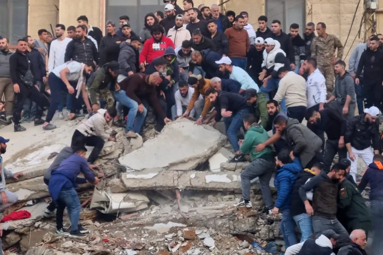 Rescue workers and residents search for survivors in the rubble 