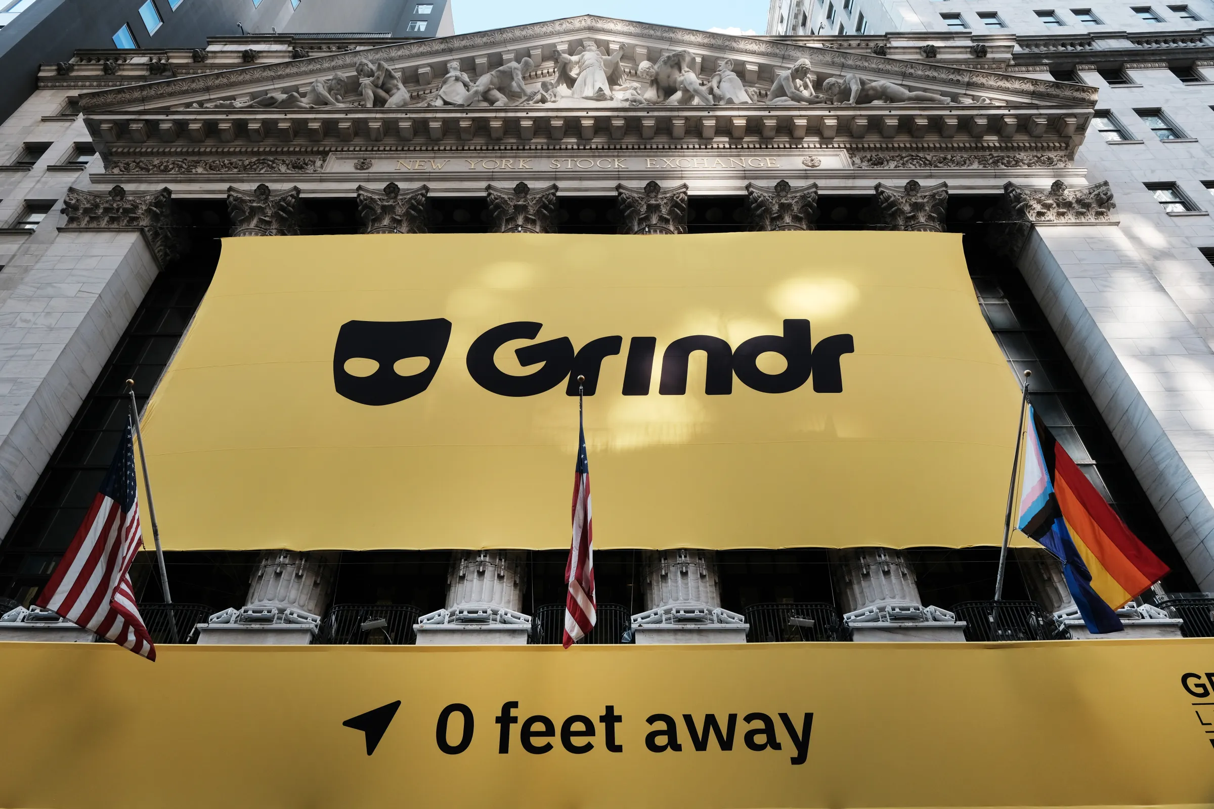 Grindr flag in front of the New York Stock Exchange