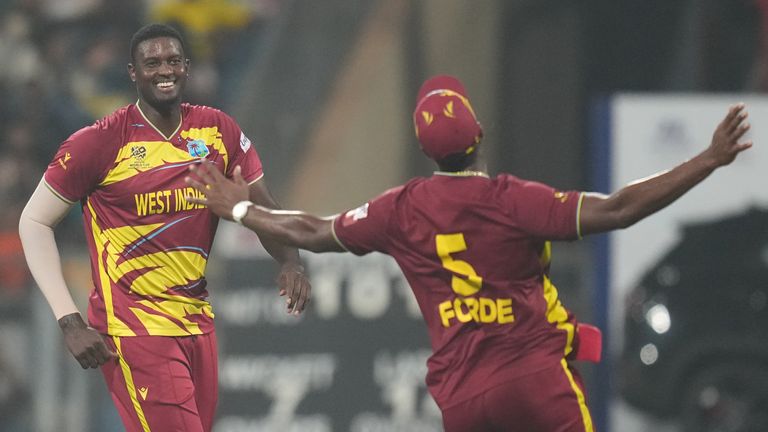 Jason Holder celebrates with Matthew Forde during the T20 World Cup cricket match between Zimbabwe and West Indies (AP Photo/Rafiq Maqbool)