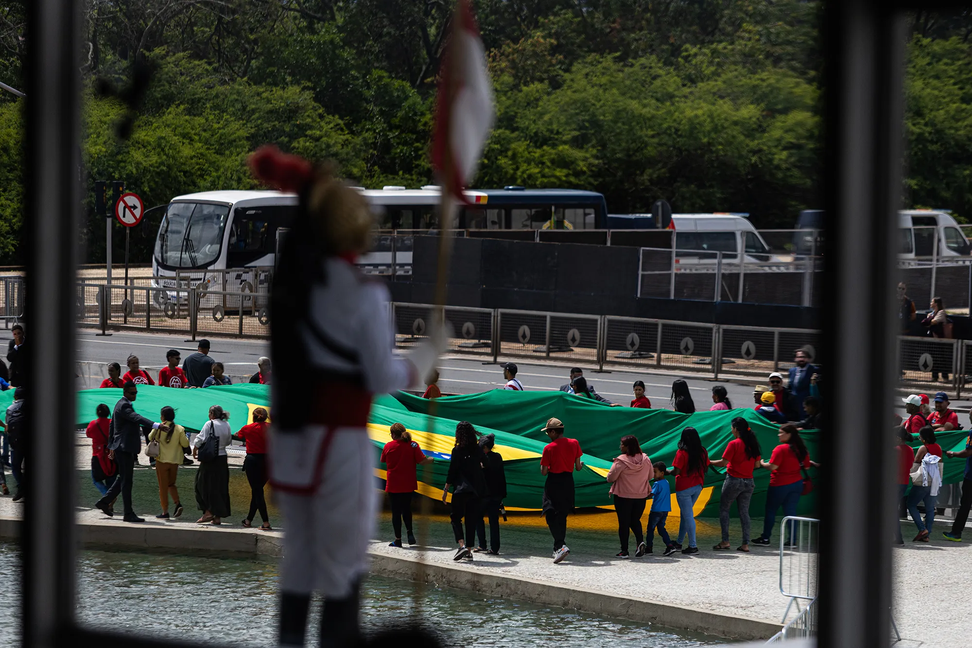 People unfurling a large Brazilian flag